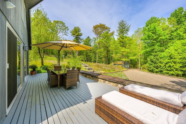 wooden terrace with outdoor dining area