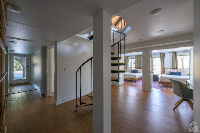 entryway featuring stairs, wood finished floors, and baseboards