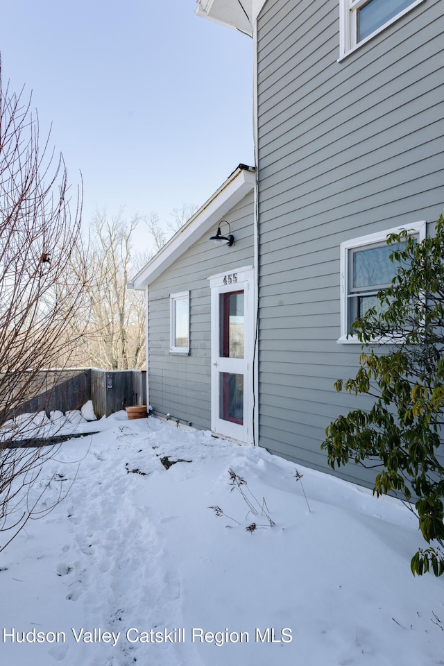 view of snow covered property entrance