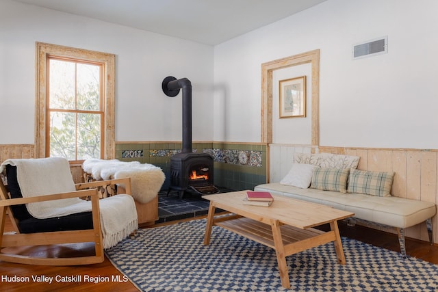 living area featuring hardwood / wood-style floors and a wood stove