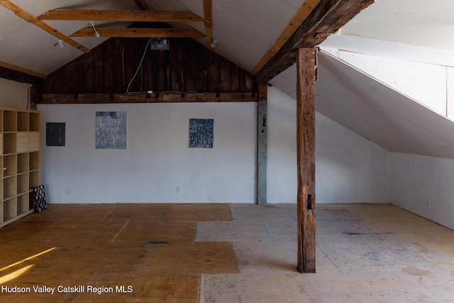 interior space with electric panel and vaulted ceiling