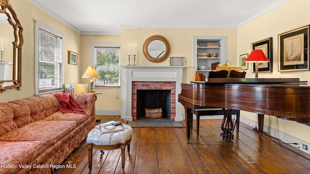7 Paul Ave, Hudson, NY 12534 - living room with radiator heating unit, wood-type flooring, built in features, a fireplace, and ornamental molding
