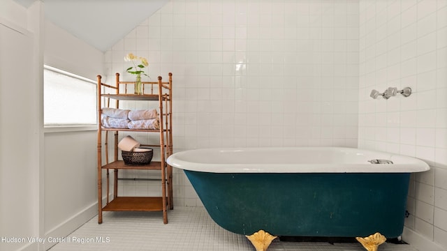 7 Paul Ave, Hudson, NY 12534 - full bath with a freestanding bath, tile walls, vaulted ceiling, and tile patterned floors