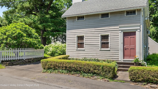 7 Paul Ave, Hudson, NY 12534 - view of front of house with entry steps, a chimney, and a shingled roof