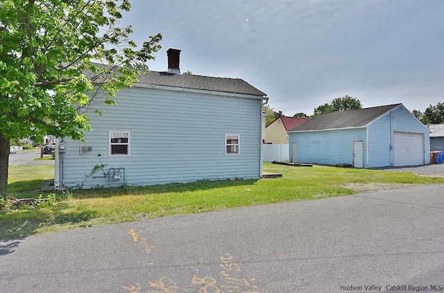 38 Emerick St, Kingston, NY 12401 - view of home's exterior featuring an outbuilding, a detached garage, and a chimney