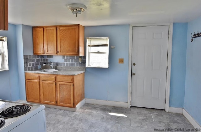 38 Emerick St, Kingston, NY 12401 - kitchen featuring light countertops, brown cabinetry, decorative backsplash, and white range with electric cooktop