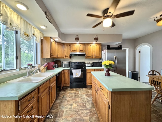 244 Jefferson Hts, Catskill, NY 12414 - kitchen with black appliances, under cabinet range hood, a sink, a ceiling fan, and stone finish flooring