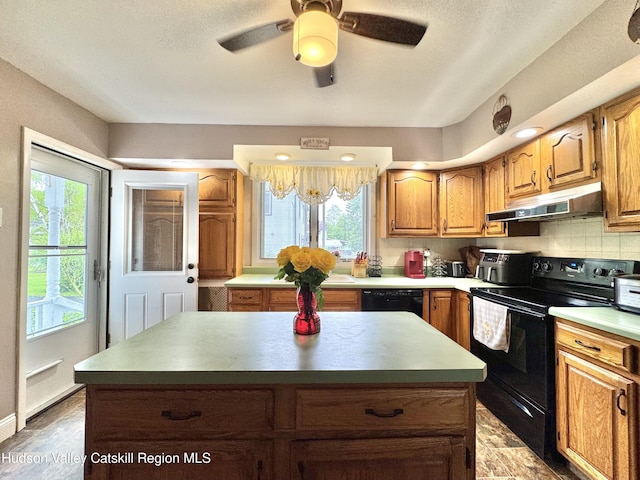 244 Jefferson Hts, Catskill, NY 12414 - kitchen featuring black appliances, under cabinet range hood, a kitchen island, ceiling fan, and brown cabinetry