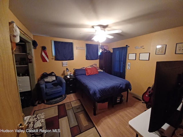 bedroom with ceiling fan and light hardwood / wood-style flooring