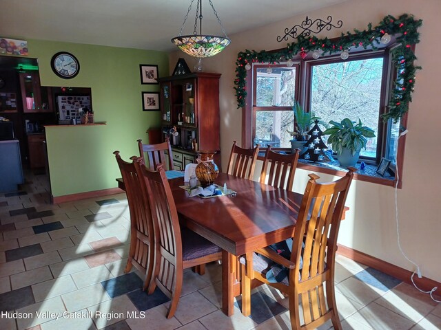 dining area with a healthy amount of sunlight and light tile patterned floors