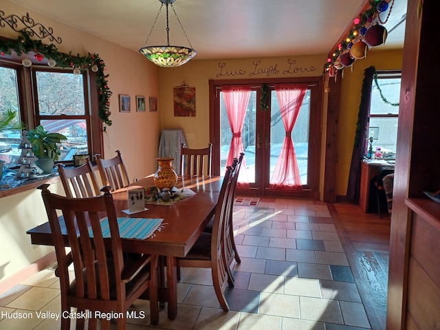 dining area featuring tile patterned flooring and french doors