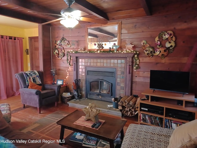 living room with beamed ceiling, wood ceiling, and wood walls