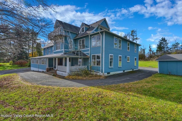 996 Dominican Ln, Saugerties, NY 12477 - view of front of home with a porch, a balcony, a front yard, and asphalt driveway