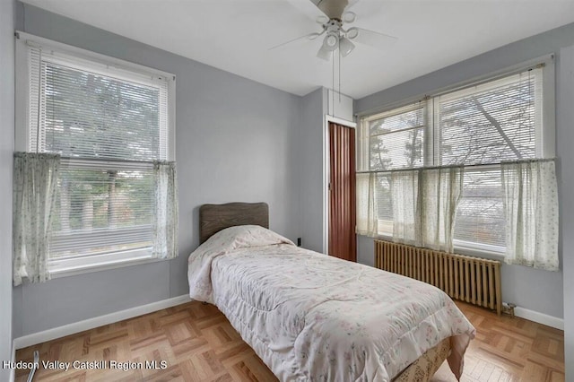 996 Dominican Ln, Saugerties, NY 12477 - bedroom featuring radiator, multiple windows, and a ceiling fan
