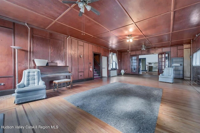 996 Dominican Ln, Saugerties, NY 12477 - living room with a ceiling fan, hardwood / wood-style flooring, stairway, healthy amount of natural light, and wooden walls