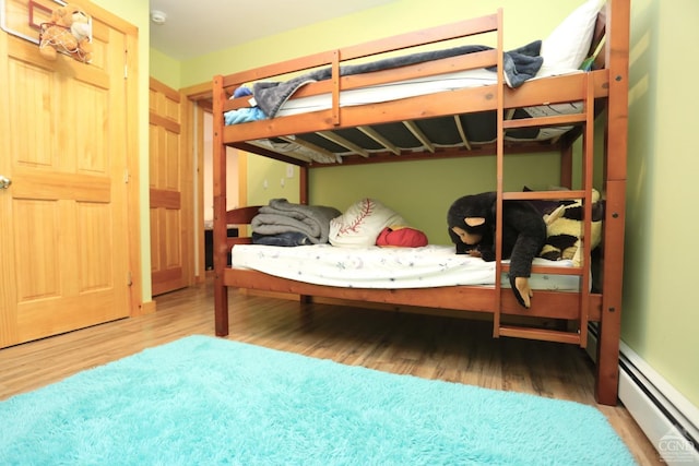454 Niles Rd, Medusa, NY 12120 - bedroom with baseboard heating and wood finished floors