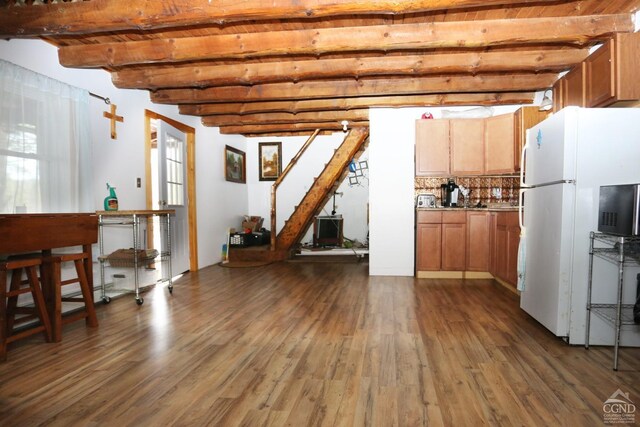 454 Niles Rd, Medusa, NY 12120 - basement with freestanding refrigerator, dark wood-style floors, and stairway