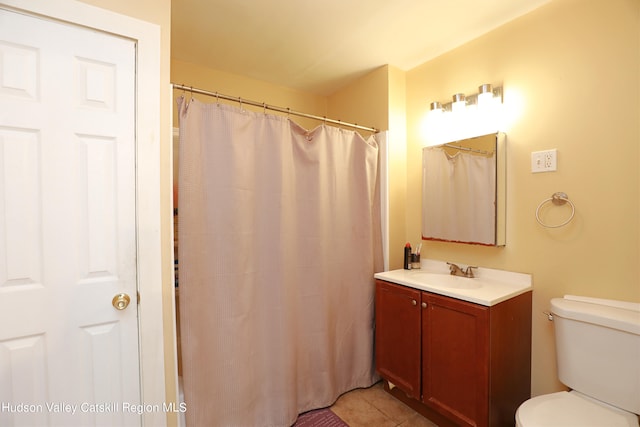 bathroom with tile patterned floors, vanity, and toilet