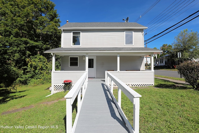 view of front of property with a porch and a front lawn