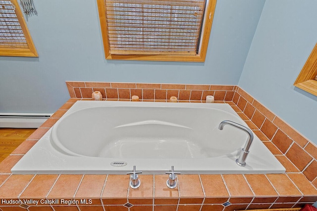 bathroom featuring a baseboard radiator and a relaxing tiled tub