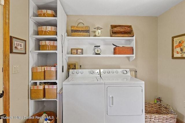 clothes washing area featuring independent washer and dryer