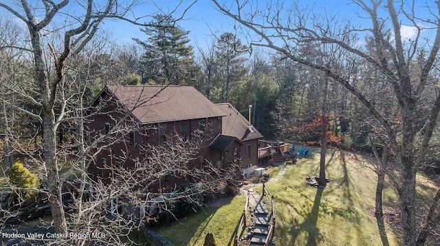 view of home's exterior featuring a deck and a lawn