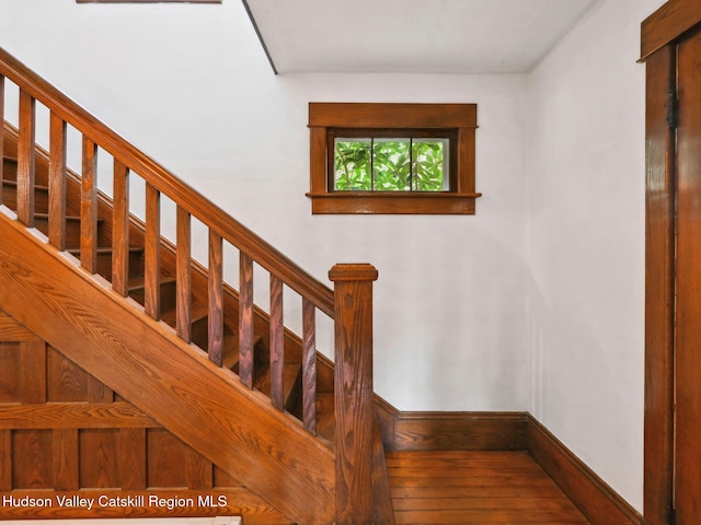 stairs featuring hardwood / wood-style flooring