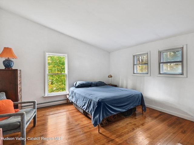 bedroom with light hardwood / wood-style flooring and multiple windows