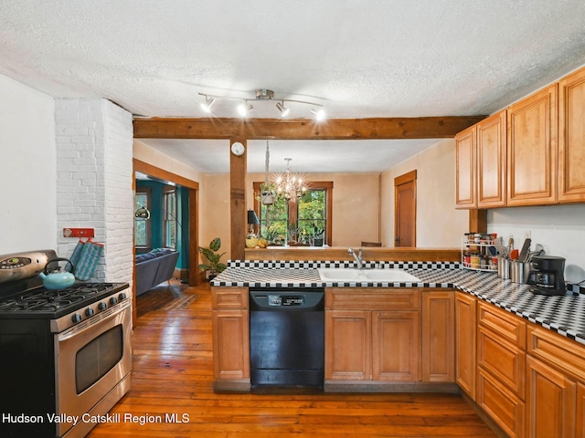 kitchen featuring stainless steel gas range, a textured ceiling, a notable chandelier, black dishwasher, and dark hardwood / wood-style floors