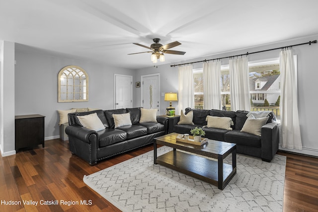 living room featuring ceiling fan, wood finished floors, and baseboards
