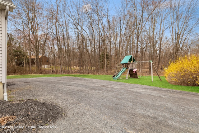 community jungle gym featuring a lawn