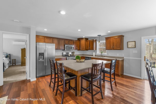 dining space with baseboards, recessed lighting, a wall mounted AC, and dark wood finished floors