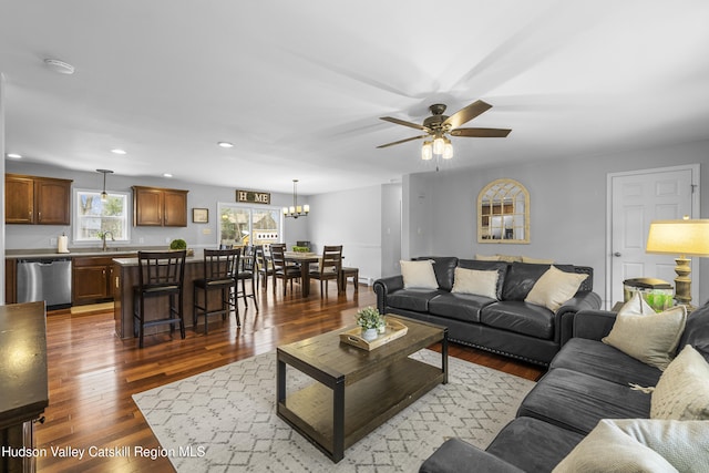 living area featuring recessed lighting, ceiling fan with notable chandelier, and hardwood / wood-style floors