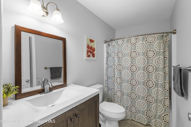 bathroom with toilet, vanity, and a shower with curtain