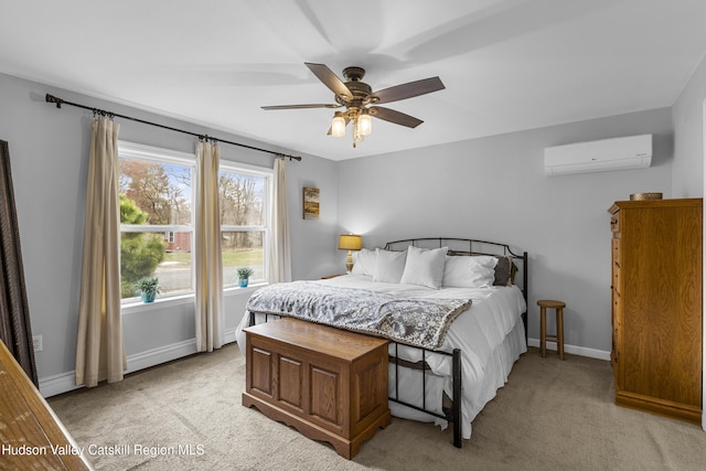 bedroom featuring light carpet, a wall mounted AC, baseboards, and ceiling fan