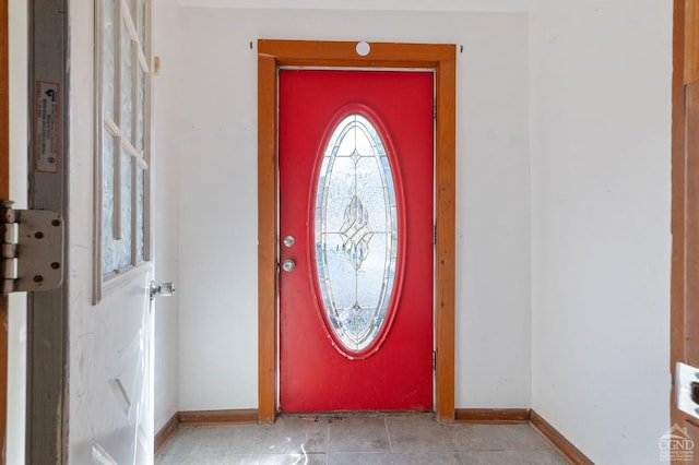foyer entrance featuring baseboards and light tile patterned floors