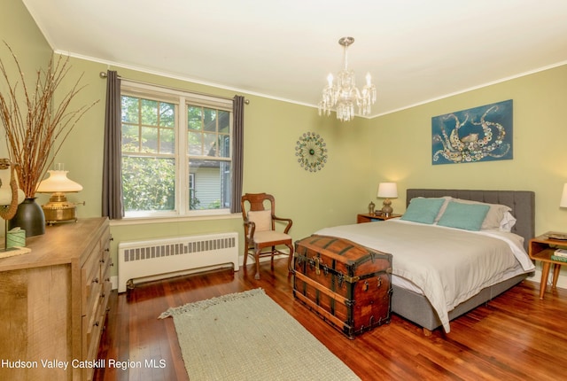 bedroom with a notable chandelier, dark hardwood / wood-style floors, radiator heating unit, and ornamental molding