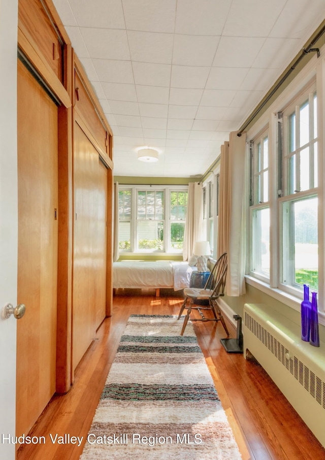 sunroom / solarium with radiator heating unit and a wealth of natural light