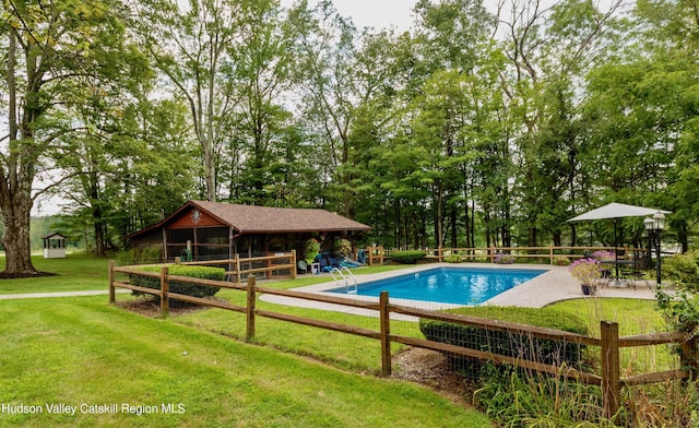 view of swimming pool with a patio and a lawn