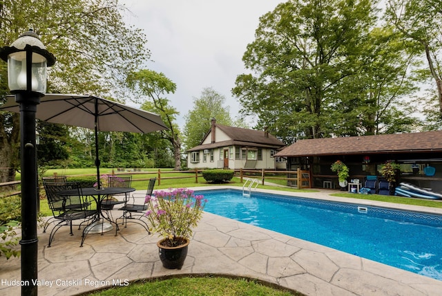 view of pool with a patio area and an outdoor structure