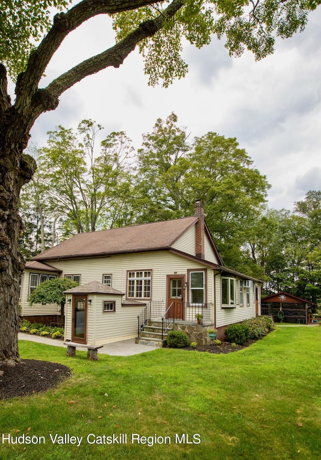 back of house with a yard