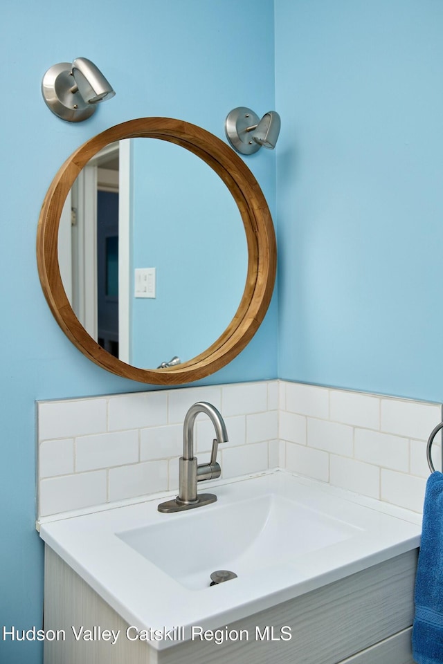 bathroom featuring tasteful backsplash and vanity