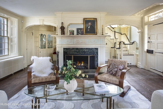 18 Striebel Rd, Woodstock, NY 12498 - living area featuring stairway, a fireplace, wood finished floors, and radiator heating unit