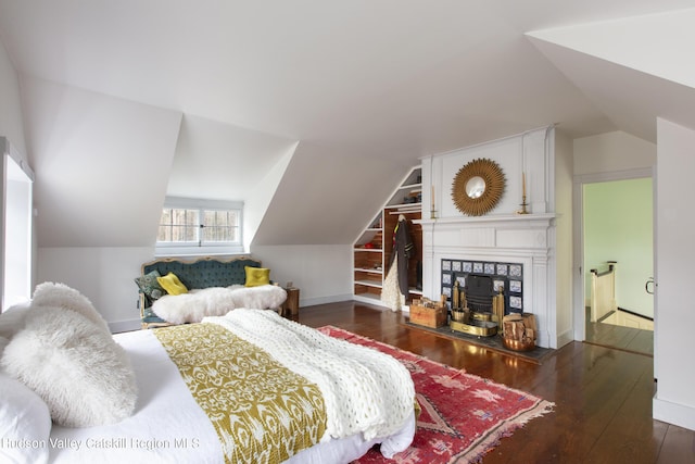18 Striebel Rd, Woodstock, NY 12498 - bedroom featuring a tile fireplace, hardwood / wood-style flooring, and vaulted ceiling