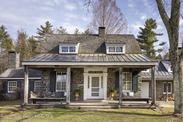 18 Striebel Rd, Woodstock, NY 12498 - view of front of home with a chimney, metal roof, a front lawn, a porch, and a standing seam roof