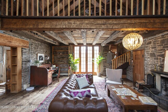 18 Striebel Rd, Woodstock, NY 12498 - living room with an inviting chandelier, beamed ceiling, french doors, and wood finished floors