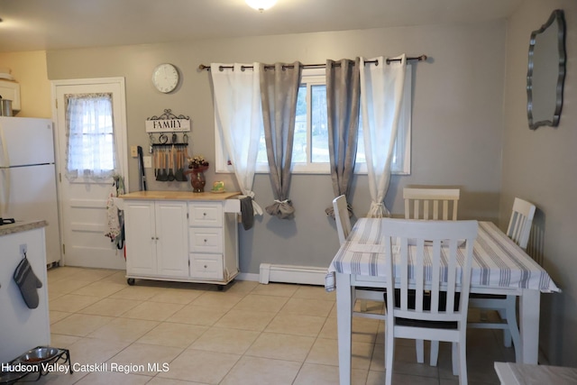 tiled dining room with baseboard heating