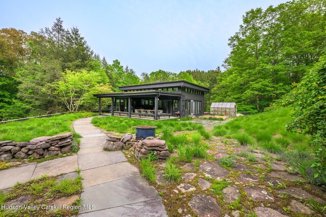 5015 Crow Hill Rd, Austerlitz, NY 12165 - view of yard featuring a greenhouse, an outbuilding, and a wooded view