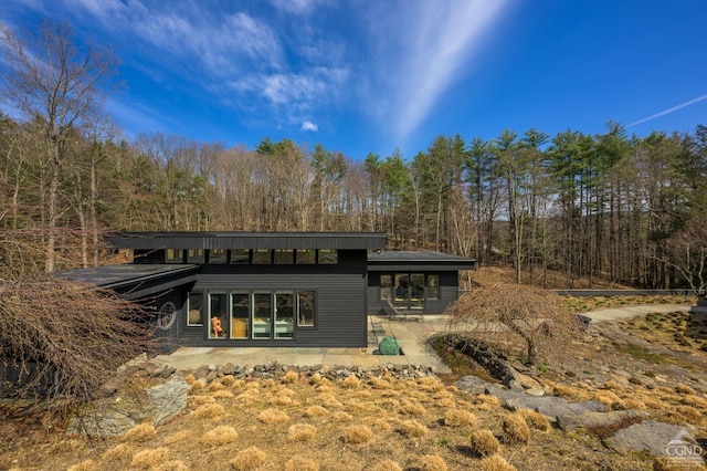 5015 Crow Hill Rd, Austerlitz, NY 12165 - back of property with a patio and a forest view