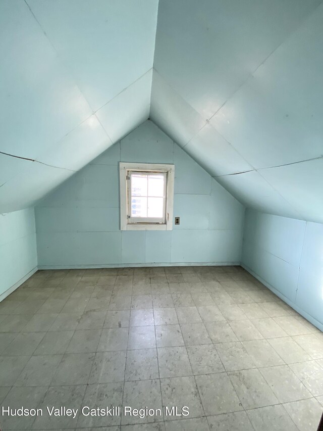 additional living space featuring lofted ceiling